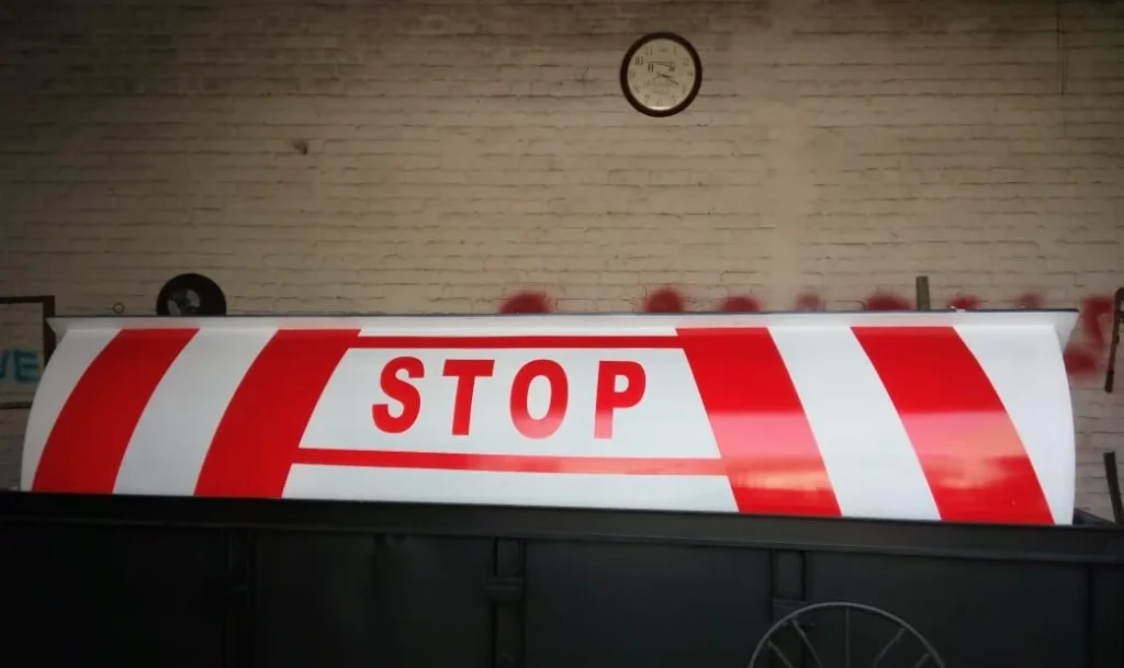Text: Automatic road blocker with STOP sign for secure vehicle access control in Pakistan