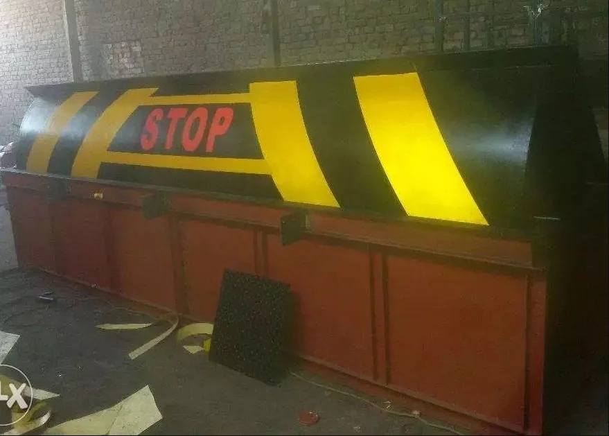 Heavy-duty hydraulic road blocker with STOP marking for secure vehicle access control in Pakistan