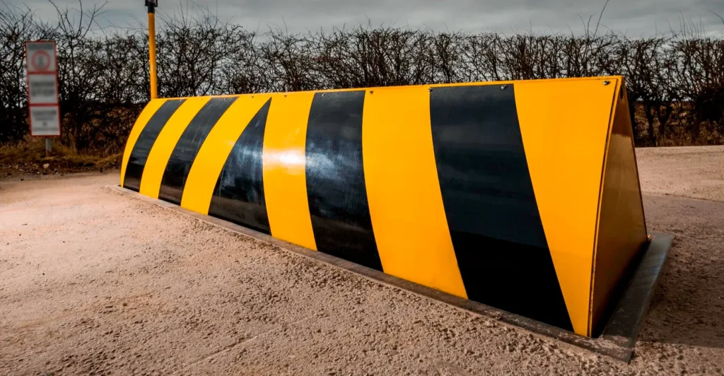 Heavy-duty road blocker with black and yellow safety markings for secure vehicle access control in Pakistan
