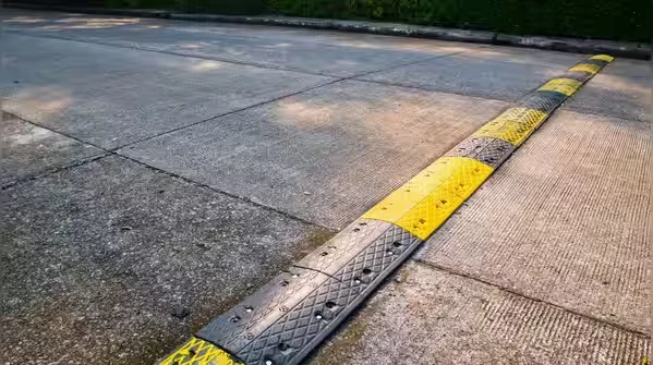 Industrial rubber speed breaker system installed for traffic control and road safety